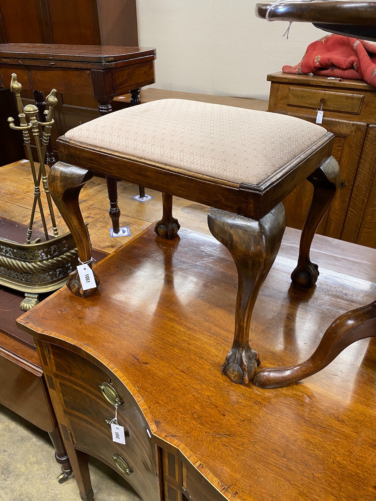 A George III style beech dressing stool on ball and claw feet, width 55cm, height 47cm.